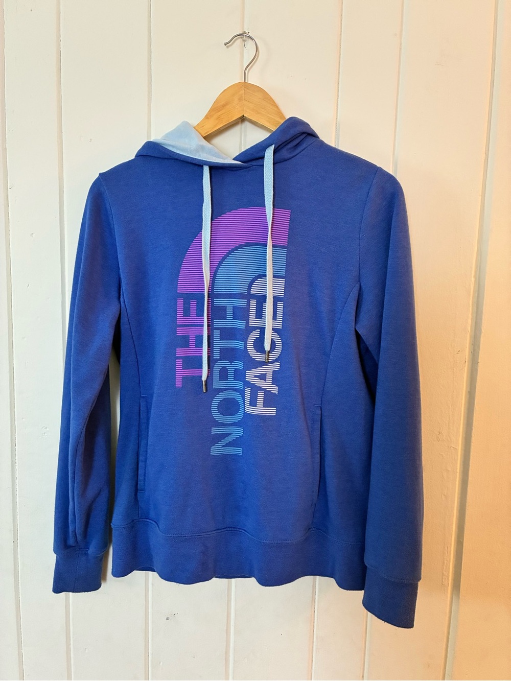 The North Face Blue Hoodie with Light Blue Lining and Purple Logo